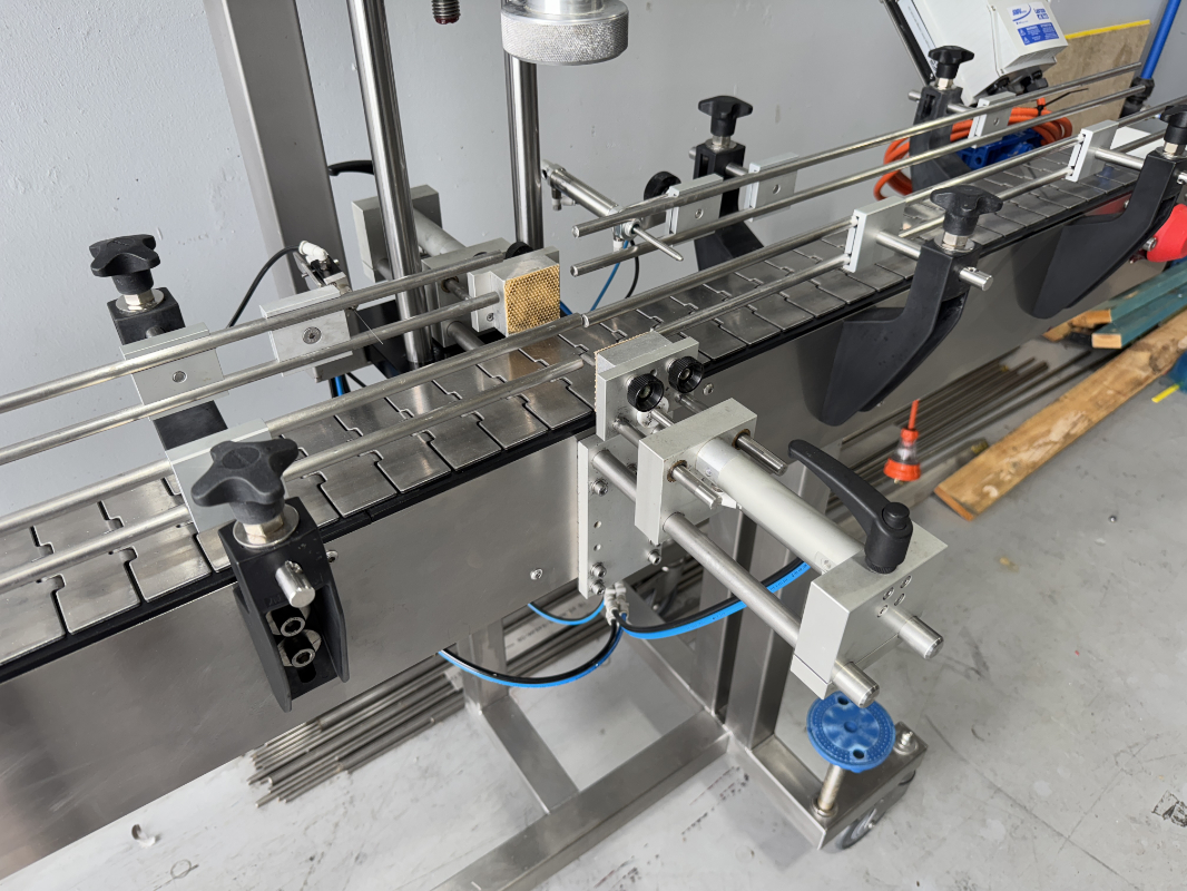 ICP auto capping jaws on slat conveyor